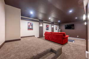 Home theater featuring carpet flooring and recessed lighting