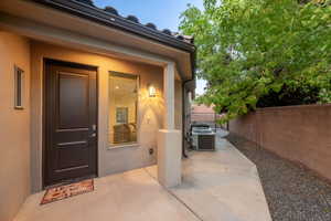 Property entrance featuring a patio area and stucco siding