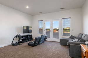 Living room with carpet flooring, french doors, and recessed lighting
