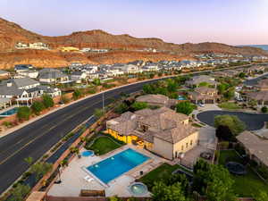 Aerial view of residential area with a mountainous background and a pool area