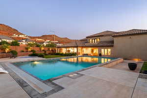 View of swimming pool featuring a patio and a mountain view