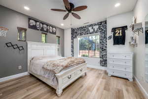 Bedroom with light wood finished floors, recessed lighting, and a ceiling fan