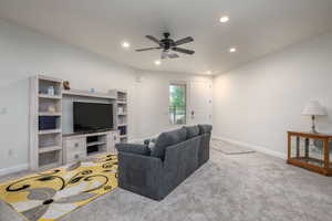 Living room with a ceiling fan, carpet floors, and recessed lighting