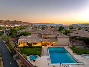 View of swimming pool with an in-ground hot tub, a fenced backyard, a patio, a residential view, and a mountain view