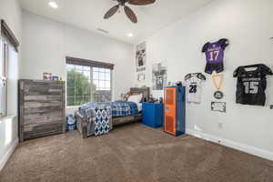 Carpeted bedroom featuring recessed lighting and a ceiling fan