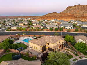 Aerial view of residential area with a mountain backdrop and a pool area