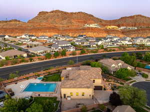 Aerial view at dusk of a mountain view, a residential view, and view of pool area