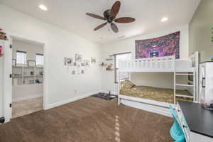 Carpeted bedroom with recessed lighting and a ceiling fan