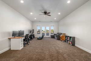 Carpeted home office featuring a ceiling fan, recessed lighting, and lofted ceiling