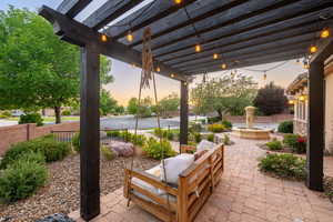 Patio terrace at dusk with a patio area and a pergola