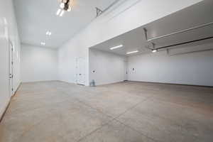Garage with a garage door opener and baseboards