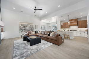 Living area featuring recessed lighting, ceiling fan, light wood finished floors, and a chandelier