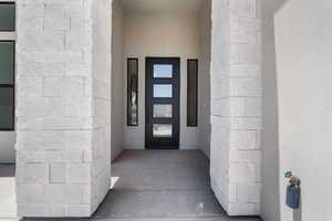 View of exterior entry with stucco siding