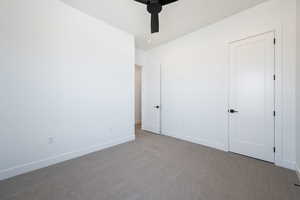 Unfurnished bedroom with carpet flooring and a ceiling fan