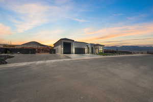 Contemporary house with a mountain view, driveway, a garage, and stucco siding