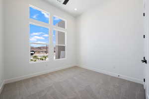 Spare room with light colored carpet, a mountain view, a ceiling fan, and recessed lighting