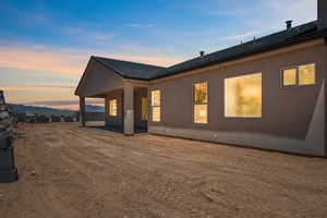 View of side of property with a patio area and stucco siding