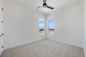 Spare room with light carpet, a ceiling fan, and recessed lighting