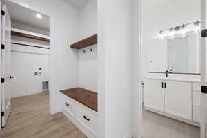 Mudroom with a sink and light wood-type flooring