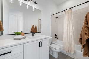 Bathroom with vanity, shower / bath combination with curtain, and tile patterned floors