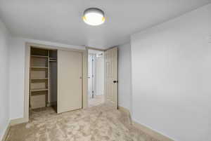 Unfurnished bedroom featuring a closet and carpet floors