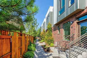 View of side of home with brick siding and a patio area