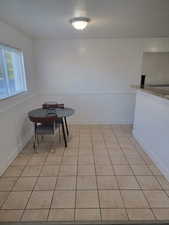 Dining room with a textured ceiling and light tile patterned floors