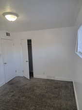 Unfurnished bedroom with carpet floors and a closet
