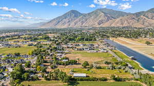 Aerial overview of property's location featuring mountains and nearby suburban area