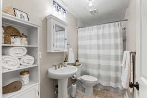Bathroom featuring tile patterned flooring and a shower with shower curtain