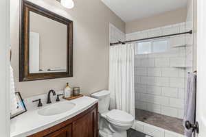 3/4 bath featuring vanity and a tile shower