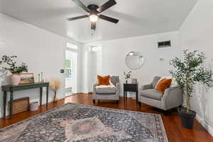 Sitting room with ceiling fan and wood finished floors
