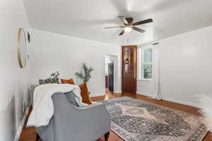 Living room featuring a ceiling fan and wood finished floors