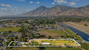 Aerial view of residential area featuring property parcel outlined and a mountainous background
