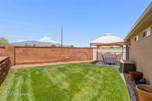 Fenced backyard featuring a mountain view