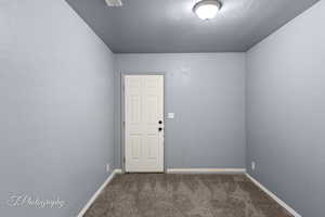 Spare room featuring carpet flooring