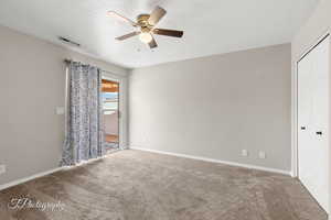 Spare room with ceiling fan and carpet floors