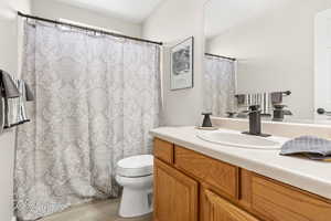 Bathroom featuring vanity and wood finished floors