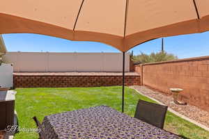 Fenced backyard featuring outdoor dining space