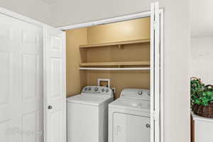 Washroom with washer and clothes dryer