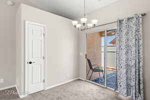 Unfurnished dining area featuring carpet floors and a chandelier