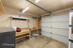Garage with a workshop area and electric panel