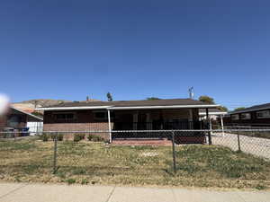 Ranch-style home with brick siding and a carport