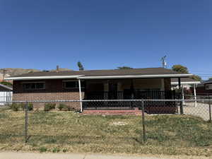 Ranch-style house featuring brick siding