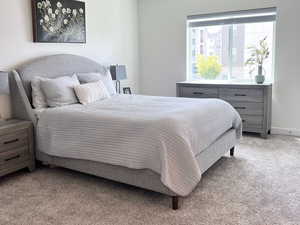 Bedroom with light carpet and a textured ceiling