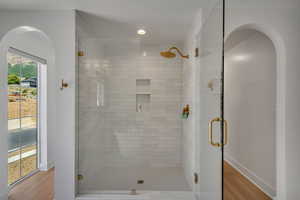 Full bath with a stall shower, wood finished floors, and recessed lighting