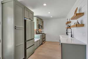 2nd basement kitchen with appliances with stainless steel finishes, open shelves, gray cabinets, recessed lighting, and light wood-type flooring