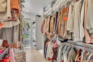 Spacious closet featuring wood finished floors