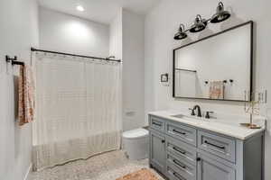 Basement bathroom with vanity, tile patterned flooring, and recessed lighting