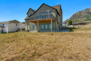 Back of property with a mountain view, stucco siding, and a balcony